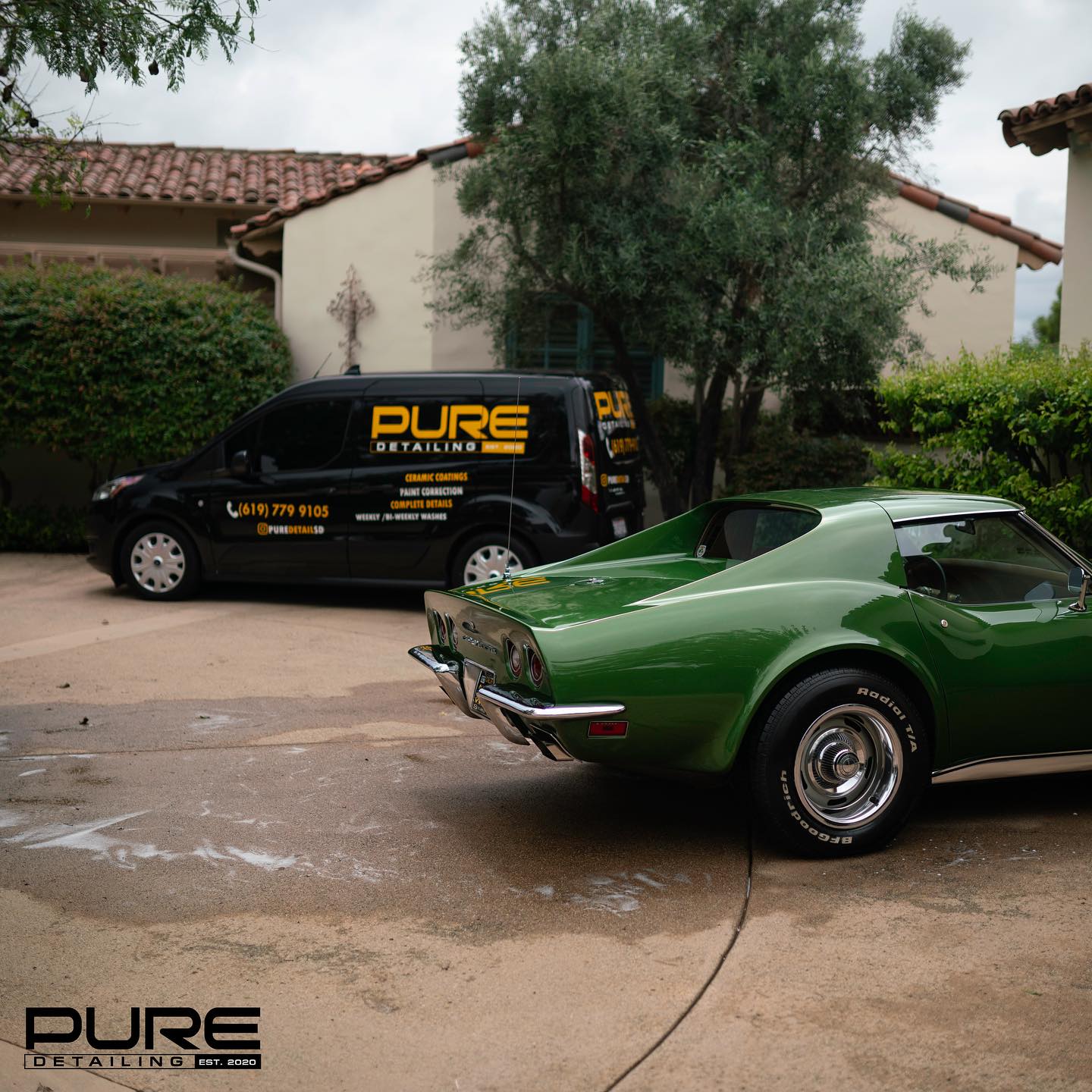 A green Corvette parked in a driveway beside the branded Pure Detailing van